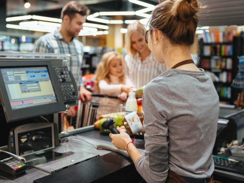 beautiful-family-standing-cash-counter-min