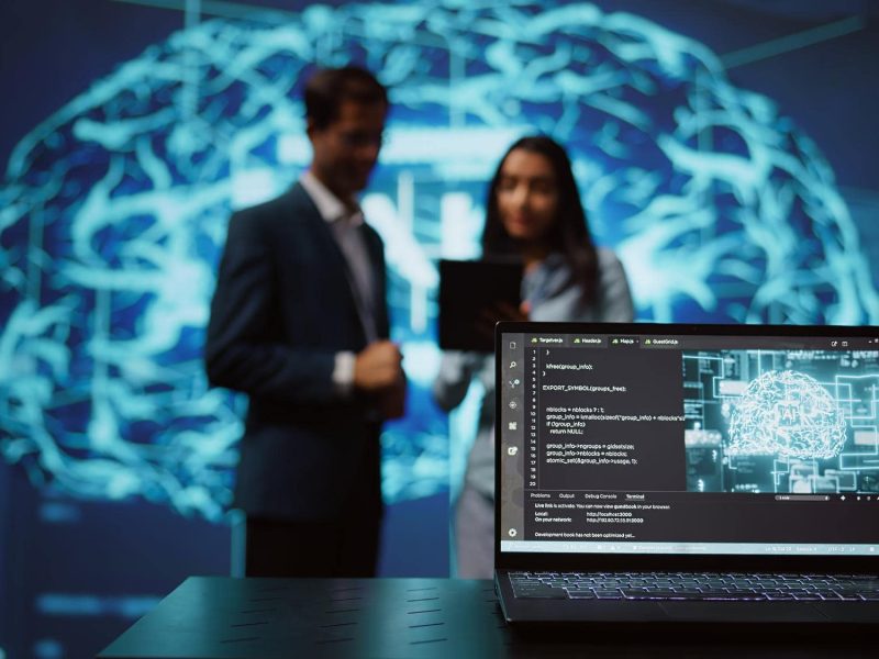 close-up-notebook-used-by-employees-developing-ai-systems-tech-startup-min
